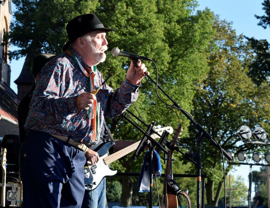 Man plays music on a sunny day at the Greeley Irish Festival