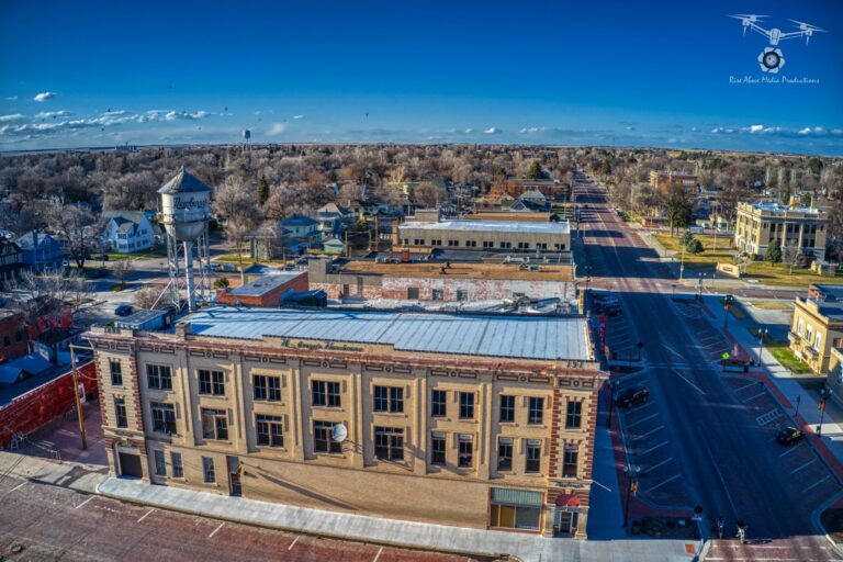 Overhead drone shot of downtown Alliance. Multiple buildings and a water tower are the focus of the image.